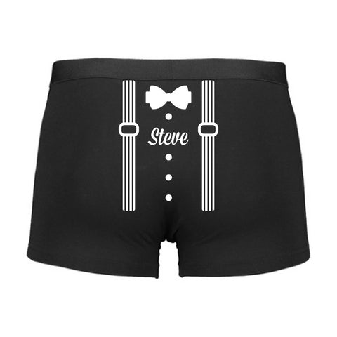 Black boxer briefs with white bow tie and suspenders design on a white background