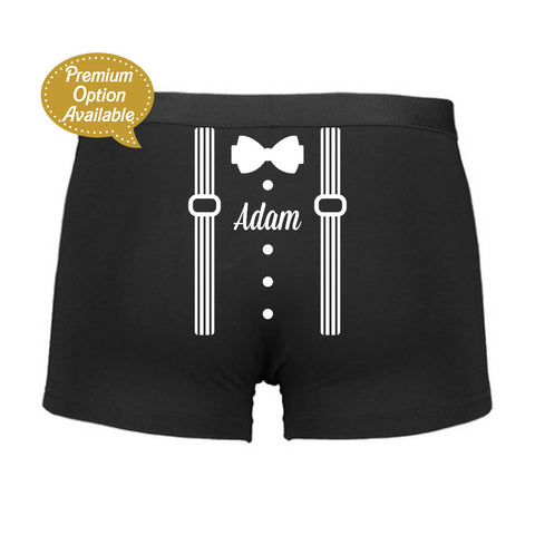 Black boxer briefs with bow tie and suspenders design on a white background