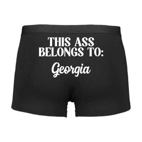 Black boxer briefs with white text on a white background