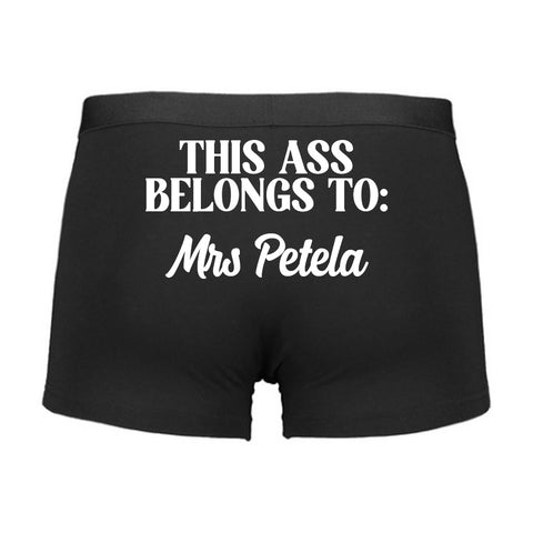 Black boxer briefs with white text on a white background